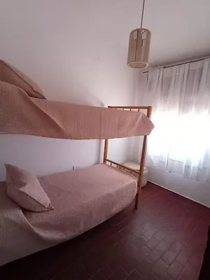a bedroom with a bunk bed and a window at chalet los condores in Villa Carlos Paz