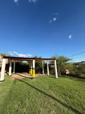 a gazebo in a park with a grass field at Complejo turistico Alto del Valle in Villa Carlos Paz