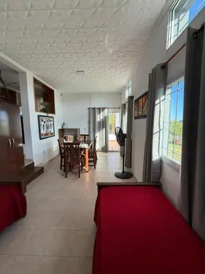 a living room with a red couch and a table at Complejo turistico Alto del Valle in Villa Carlos Paz