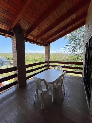 a table and chairs on a deck with a view at Los Cardones de Mayu in San Antonio de Arredondo