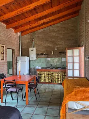a kitchen with a table and chairs in a room at Los Cardones de Mayu in San Antonio de Arredondo