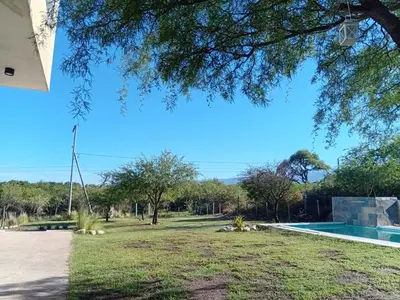 a view of a yard with a swimming pool at Lashara in Las Rabonas