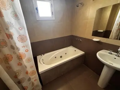 a bathroom with a bath tub and a sink at Alma Apart in Los Molles