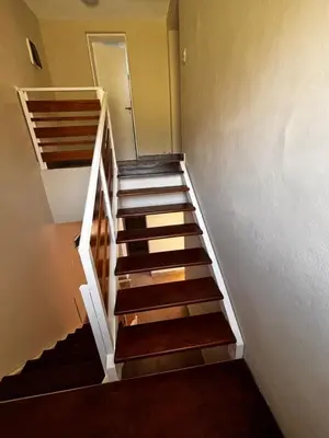 a staircase with wooden steps in a room at Alma Apart in Los Molles