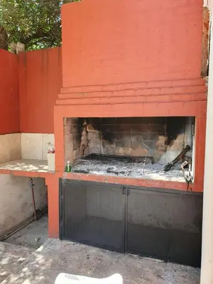 a red brick oven with a fire inside of it at Alma Apart in Los Molles
