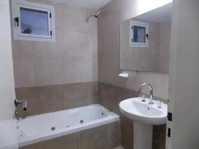a bathroom with a sink and a bath tub and a sink at Alma Apart in Los Molles