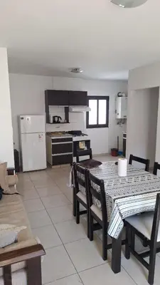 a kitchen and dining room with a table and chairs at 9 de Julio 460 in Villa Carlos Paz