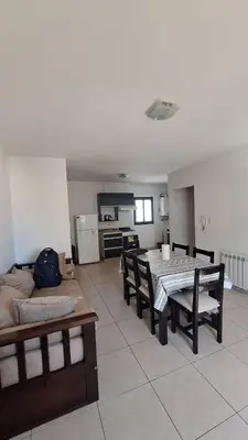 a living room with a table and a couch at 9 de Julio 460 in Villa Carlos Paz