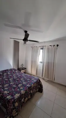 a bedroom with a bed and a ceiling fan at 9 de Julio 460 in Villa Carlos Paz