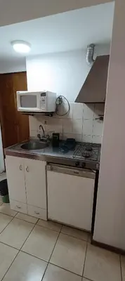 a small kitchen with a sink and a microwave at Complejo Aguaducho in Cordoba