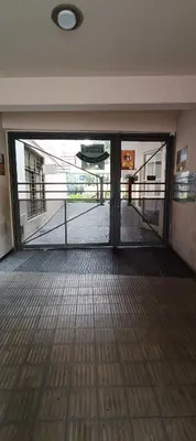 an empty room with a glass door in a building at Complejo Aguaducho in Cordoba