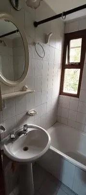 a bathroom with a sink and a tub and a mirror at Complejo Aguaducho in Cordoba