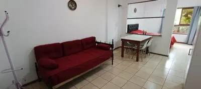 a living room with a red couch and a table at Complejo Aguaducho in Cordoba