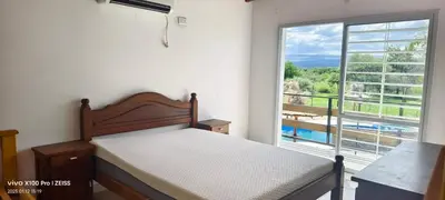 a bedroom with a bed and a large window at DUPLEX Stadium in Tanti