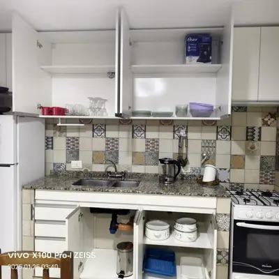 a kitchen with white cabinets and a sink at DUPLEX Stadium in Tanti