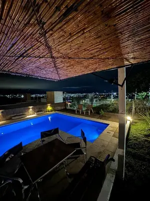 a swimming pool in a backyard at night at Vistas del Valle II in Villa Carlos Paz