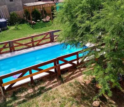a wooden fence next to a swimming pool at La Serranita in Panaholma