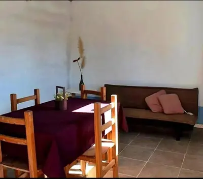 a living room with a table and a couch at La Serranita in Panaholma
