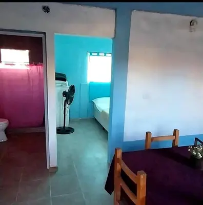 a room with a bedroom with a bed and a window at La Serranita in Panaholma