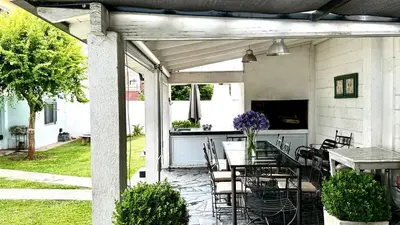 an outdoor patio with a table and chairs at Apartment 2 blocks from downtown Located at the back of the house in Villa Carlos Paz