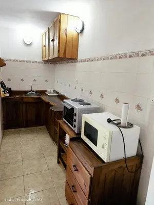 a kitchen with a microwave on top of a counter at Mirador De Las Sierras in Villa Serranita