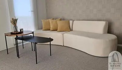a living room with a couch and a table at The Thirty Floor Sky Suite in Cordoba