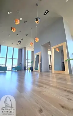 a large room with a wooden floor and lights on the ceiling at The Thirty Floor Sky Suite in Cordoba