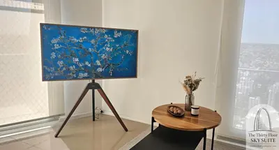 a painting on a stand in a room with a table at The Thirty Floor Sky Suite in Cordoba