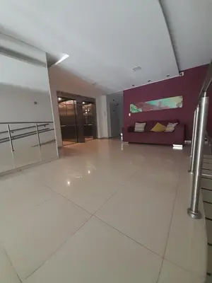 a large living room with a couch in a building at Departamento luminoso a 4 cuadras del centro in Río Cuarto