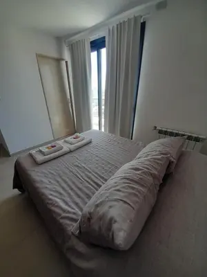 a large bed in a bedroom with two pillows on it at Departamento luminoso a 4 cuadras del centro in Río Cuarto