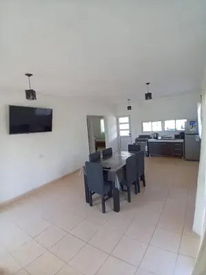 a dining room with a table and chairs at Casa con pileta mina clavero in Mina Clavero