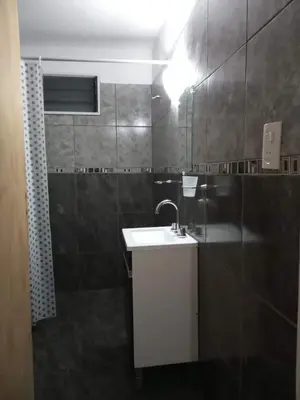 a bathroom with a white sink and a mirror at Casa con pileta mina clavero in Mina Clavero