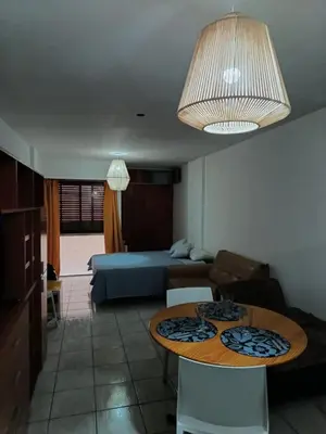 a living room with a table and a bed at Dpto 1 Ambiente Nva Cordoba, Capuchinos Buen Pastor in Cordoba