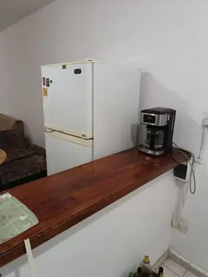 a kitchen with a refrigerator and a coffee maker on a counter at Dpto 1 Ambiente Nva Cordoba, Capuchinos Buen Pastor in Cordoba
