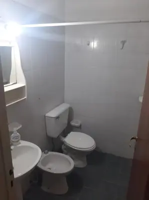 a white bathroom with two toilets and a sink at Dpto 1 Ambiente Nva Cordoba, Capuchinos Buen Pastor in Cordoba