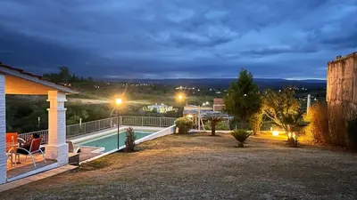 a backyard with a swimming pool at night at Casa- Villa Parque Siquiman in Villa Parque Siquiman