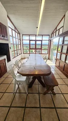 a dining room with a wooden table and chairs at Casa- Villa Parque Siquiman in Villa Parque Siquiman