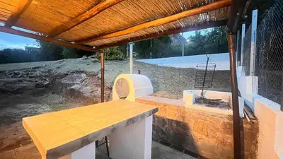 a porch with a bench and a grill at Casa- Villa Parque Siquiman in Villa Parque Siquiman