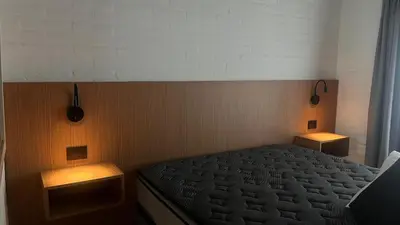 a bedroom with a bed with two lights on it at Casa- Villa Parque Siquiman in Villa Parque Siquiman