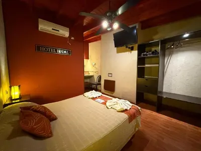 a bedroom with a bed in a room with a projector at Hotel Ideal vcp in Villa Carlos Paz