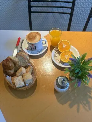 a table with a cup of coffee and a basket of bread at Hotel Ideal vcp in Villa Carlos Paz