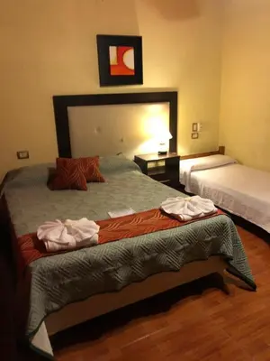 a hotel room with a bed with towels on it at Hotel Ideal vcp in Villa Carlos Paz
