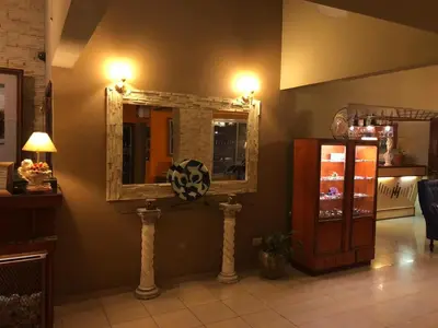 a room with a mirror on the wall and a refrigerator at Hotel Ideal vcp in Villa Carlos Paz