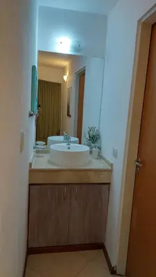 a bathroom with a sink and a large mirror at Mirasol in Villa Carlos Paz