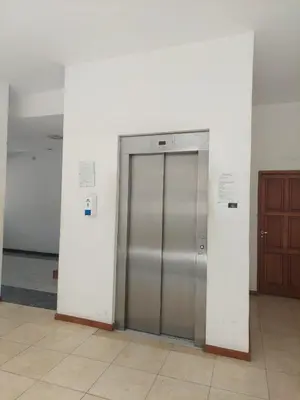a metal elevator in a building with a door at Mirasol in Villa Carlos Paz