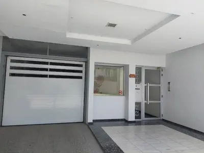 an empty garage with a white garage door in a room at Mirasol in Villa Carlos Paz