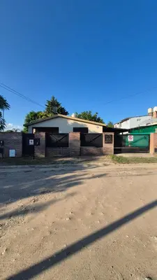 a building on the side of a dirt road at La Casa del Gran Nogal in Villa Carlos Paz