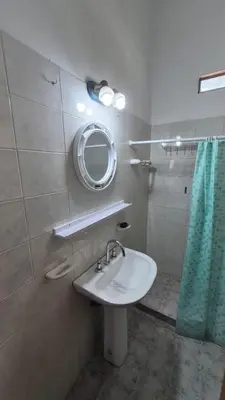 a bathroom with a sink and a mirror at La Casa del Gran Nogal in Villa Carlos Paz