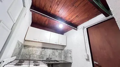 a kitchen with a sink and a wooden ceiling at Monoambiente a metros del río in Tanti