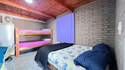a small bedroom with a bed and a window at Monoambiente a metros del río in Tanti